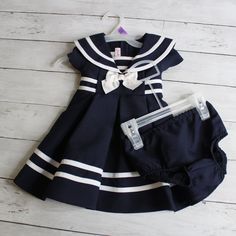 Jessica Ann Navy Blue And White Sleeveless Sailor Dress With Matching Diaper Cover Baby Girl Size 12 Months This Nautical Dress Is Darling. It Is Navy Blue And White With White Stripes, Bow And Gold Tone Button Accents. It Has A Sailor Collar With A Back Zipper Fastener And Sash. It Is New Without Tags And Is In Brand New Condition. Hanger Not Included. 100% Polyester Spring Easter Summer Fall Nautical Blue Sailor Cotton Dress, Blue Cotton Sailor Dress, Navy Nautical Cotton Dress, Nautical Navy Cotton Dress, Blue Sailor Style Cotton Dress, Sailor Style Blue Cotton Dress, Navy Cotton Nautical Dress, Navy Marine Style Summer Dress, Spring Nautical Cotton Dress