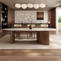 a modern dining room with an oval table surrounded by white chairs and wooden cabinets, along with large windows