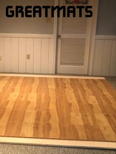 a wooden floor with the words greatmats on it in front of a door