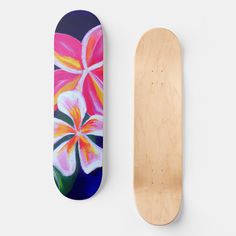 two skateboards with flowers painted on them next to each other