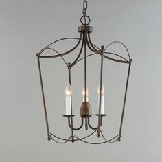 a chandelier with three candles hanging from it