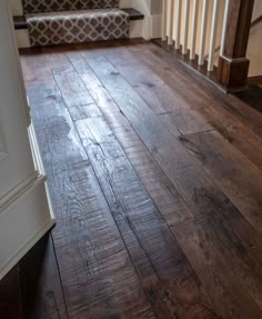 a wooden floor in a house with stairs