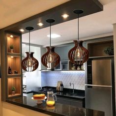 three lights hanging from the ceiling in a kitchen