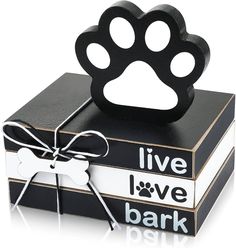 a black and white box with a dog's paw on it, tied in a ribbon