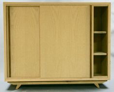 a wooden cabinet sitting on top of a white floor