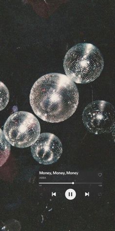 several disco balls hanging from the ceiling in front of a mirror ball wallpapered background