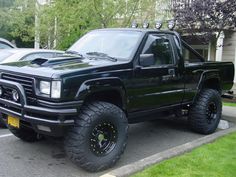 a black pickup truck parked in a parking lot