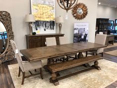 a dining room table and bench in a store