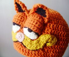 an orange crocheted hat with angry birds on it