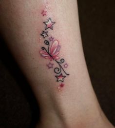 a woman's foot with a pink butterfly tattoo on the left side of her leg