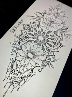 an intricate flower tattoo design on a sheet of paper