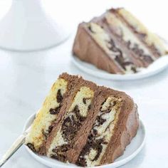 two slices of chocolate cake on white plates