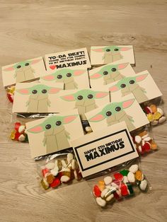 star wars candy bags with yoda and marshmallows in them on a wooden table