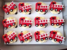 cupcakes decorated like fire trucks in a box