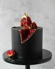 a black cake with red and gold decorations