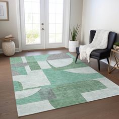 a living room with a chair and rug on the floor