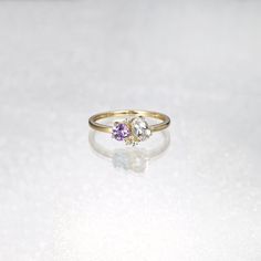 two stone ring sitting on top of a white surface