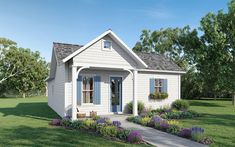 a small white house sitting on top of a lush green field