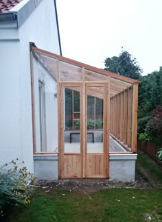 a small house with a wooden door and glass windows