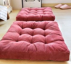 two futon mattresses sitting on top of a wooden floor