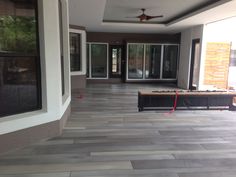 an empty room with hard wood flooring and sliding glass doors on the outside wall