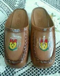 brown slippers with embellishments on them