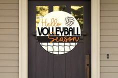 a door with a sign that says hello volleyball season on it and an orange net in the center