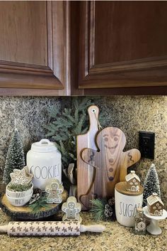 the kitchen counter is covered with wooden utensils and christmas decorations, including cookie cutters