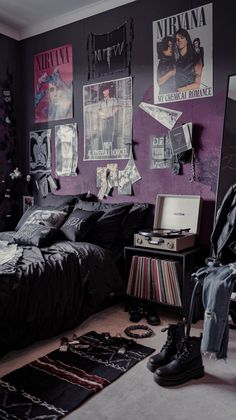 a bedroom with purple walls and posters on the wall