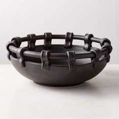 a black bowl sitting on top of a white counter