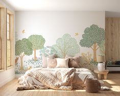 a bed sitting in a bedroom next to a wall with trees painted on the walls