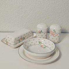 a white table topped with plates and bowls