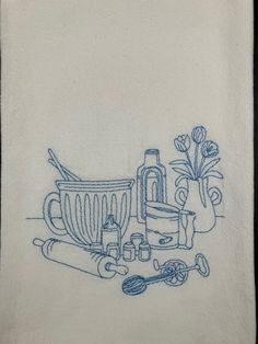 a kitchen towel with an image of utensils and cooking implements on it in blue ink