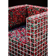 several red and green boxes stacked on top of each other in front of a black background