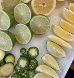 sliced up lemons, cucumbers and peppers on a cutting board