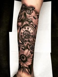 a person with a clock and flowers tattoo on their leg