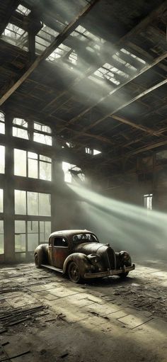 an old car is parked in a large warehouse