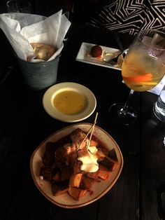 a table topped with plates of food and drinks