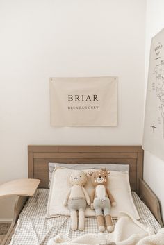 two teddy bears sitting on top of a bed