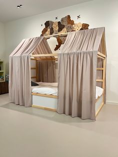 a bunk bed with curtains over it in a room