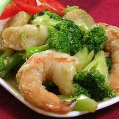 shrimp, broccoli and peppers on a white plate