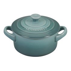 a blue casserole with a lid and handle is shown on a white background