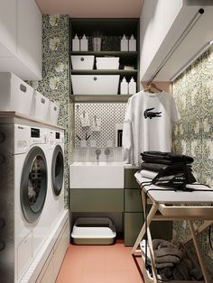 a washer and dryer in a small room next to a laundry area with green wallpaper