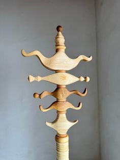 a tall wooden sculpture sitting on top of a table