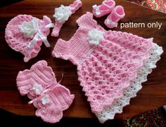 a crocheted baby outfit and booties on a table