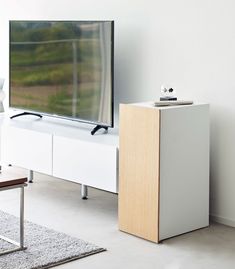 a flat screen tv sitting on top of a white entertainment center