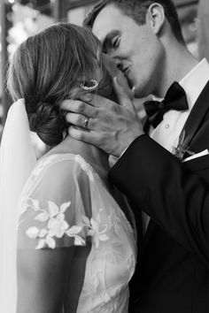 the bride and groom are kissing each other