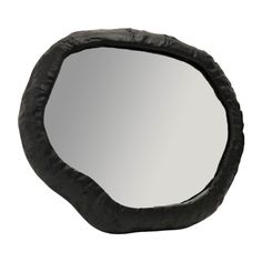 a mirror that is made out of black leather and has an oval shape on it