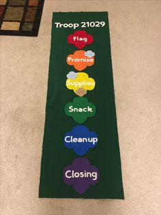 a long green banner with the words troop 1209 on it, and five different colors