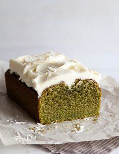 a piece of green cake with white frosting